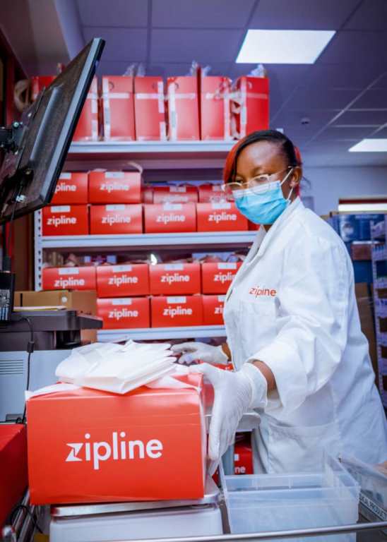 Zipline official getting ready medical supply for delivery