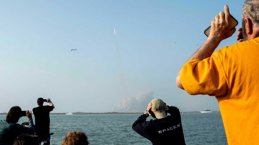 Spacex employees watch during Starship Rocket launch