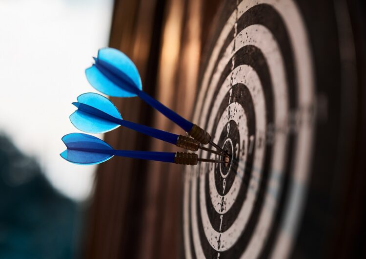 Side view of vintage darts board game with arrow in it in the sunset lights (Image credit: iStock)