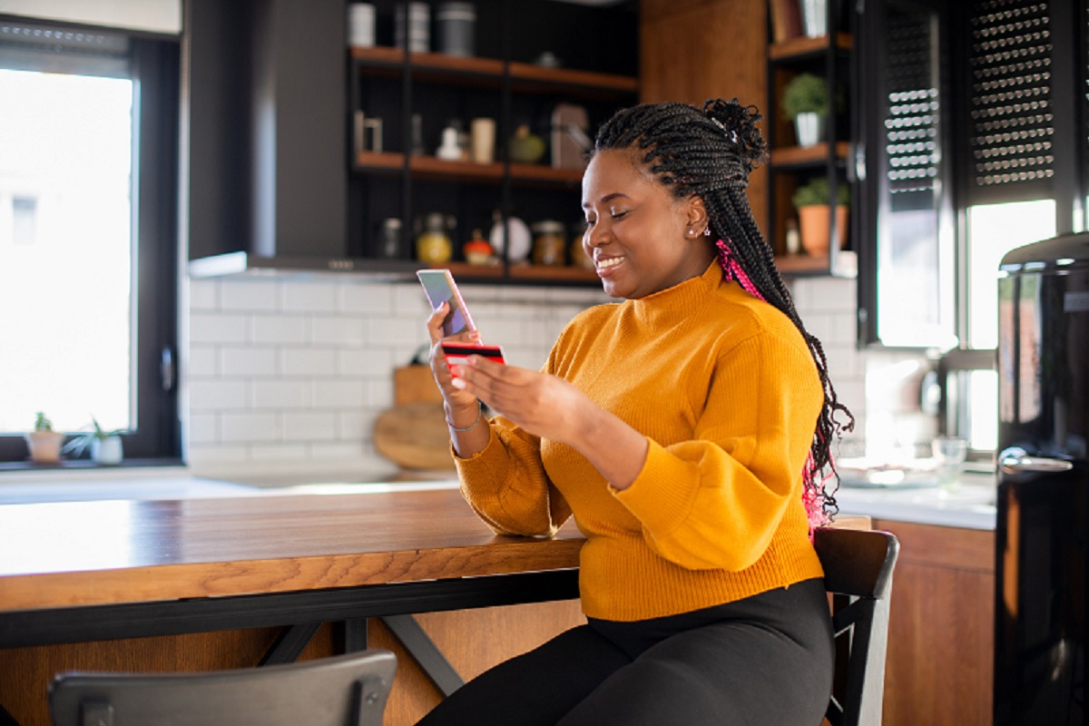 Woman using her credit card to shop online