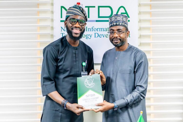 Google West Africa Director, Olumide Balogun, and the Director General, National Information Technology Development Agency (NITDA), Kashifu Inuwa, CCIE, while presenting the former with NITDA'S Strategic RoadMap and Action Plan (SRAP) document, during a visit to NITDA'S corporate headquarters, in Abuja