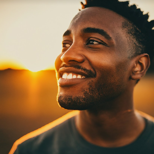 Gemini Pro in Nigeria - A close up of a smiling man wearing a green shirt with short hair