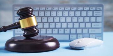 Judge gavel with computer mouse keyboard - Policy Cafe