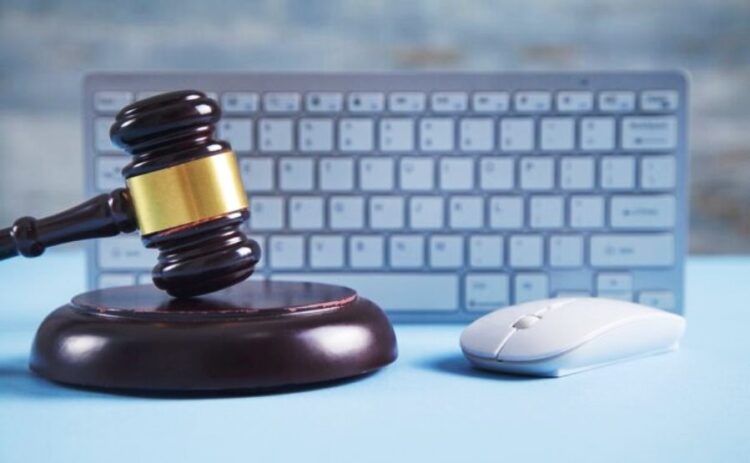 Judge gavel with computer mouse keyboard - Policy Cafe