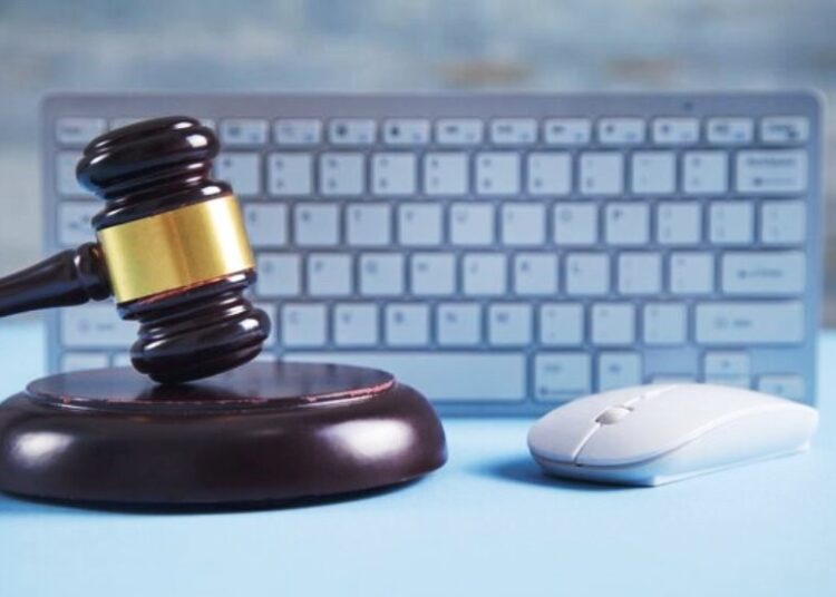 Judge gavel with computer mouse keyboard - Policy Cafe