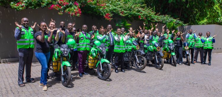 Group photo of Bolt, MKOPA, ROAM and Ampersand teams with the riders