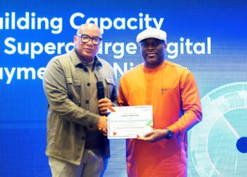 Mitchell Presents Certificate of Participation at the Interswitch training for HoR members