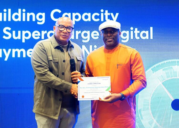 Mitchell Presents Certificate of Participation at the Interswitch training for HoR members