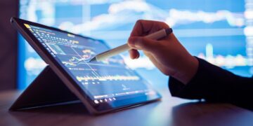 Crowdstrike outage - Woman looking stock market Data on smart phone