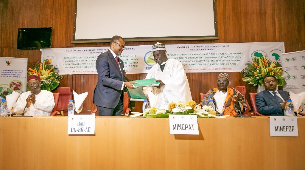 Mey and Bassolé exchange documents after signing the agreements